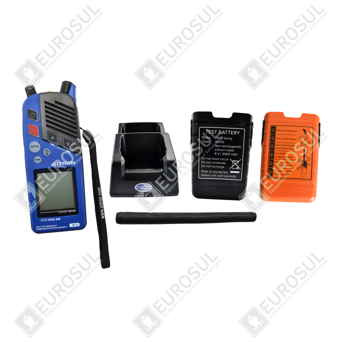 Jotron TR30 AIR AM radio with charger, test battery, orange emergency battery, and power supply, top view.