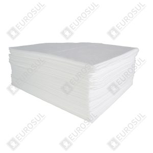 Stack of oil absorbent sheets, 40x50 cm, side view, showing thickness and texture in a clean, industrial setting.